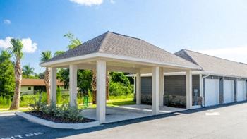 A building with a covered parking area in front at Mode at Melbourne, LLC Apartments, Florida