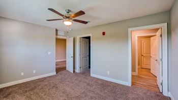 A room with a ceiling fan and carpeted floor at Mode at Melbourne, LLC Apartments, Florida, 32901