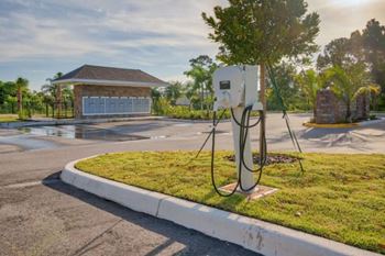 A charging station for electric vehicles is located in a grassy area in front of a house at Mode at Melbourne, LLC Apartments, Melbourne, 32901
