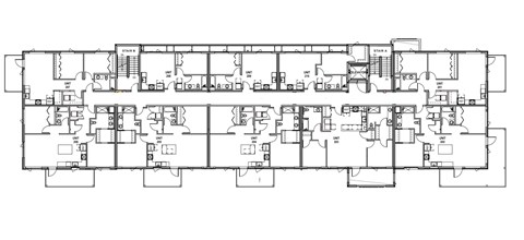 A floor plan of a building with multiple rooms and corridors.