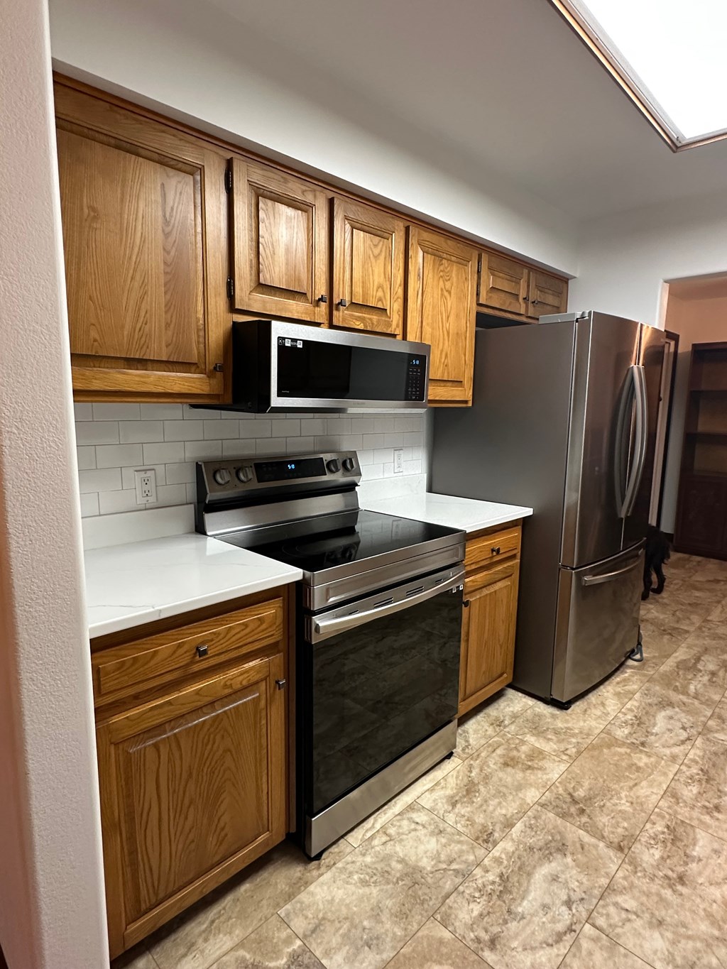 A kitchen with wooden cabinets and stainless steel appliances.
