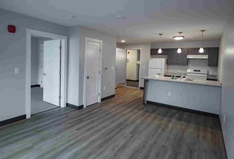 A kitchen with a white fridge and a white stove top oven.