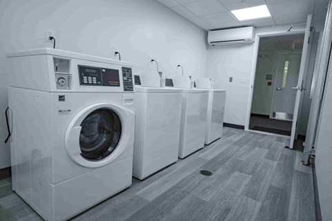 A row of washing machines in a laundromat.
