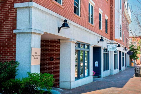 A building with a sign that says "The Squash Block".