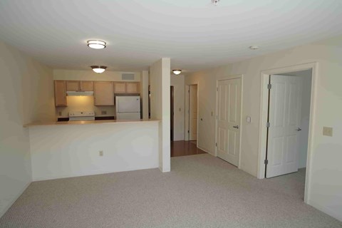 A kitchen area with a refrigerator, oven, and microwave.