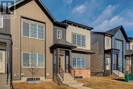 A row of modern houses with different facades and front yards.