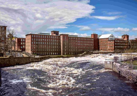 A river flows through a city with buildings on both sides.