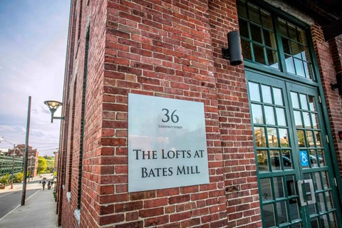 A sign on a brick wall that says