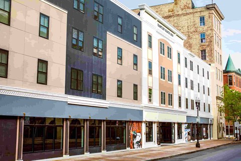 A street view of a row of buildings with a clear sky in the background.