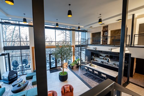 A modern interior space with a bar and seating area.