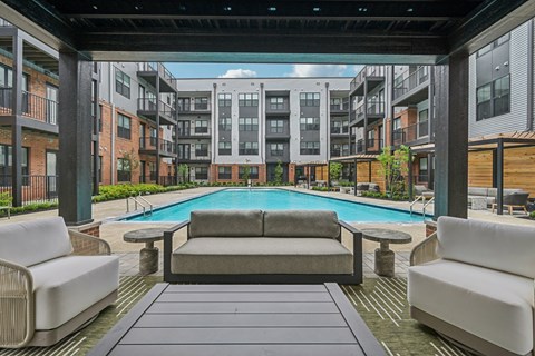 A patio with a pool surrounded by buildings.