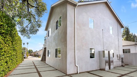 A house with a concrete exterior and a grey roof.