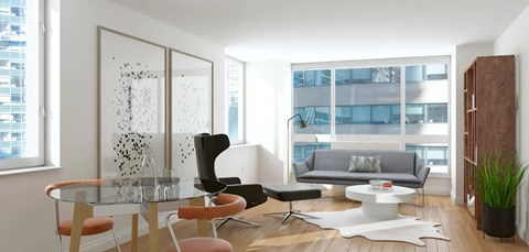 A modern living room with a glass table and chairs.