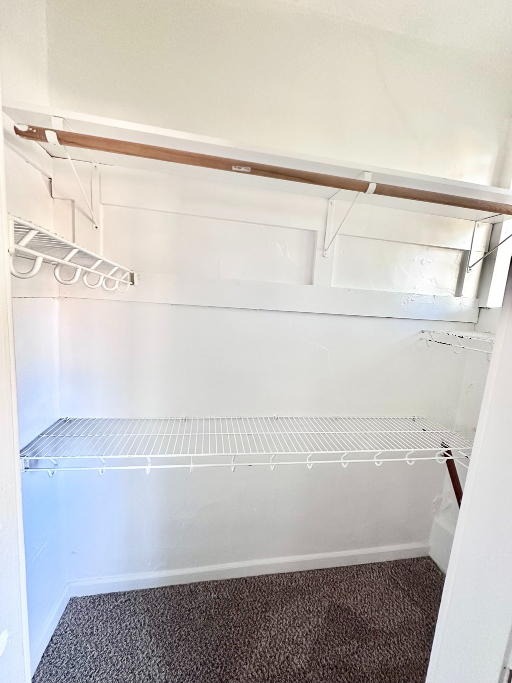 A room with carpeted floor and white walls.