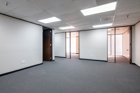 A room with a white wall and a carpeted floor.
