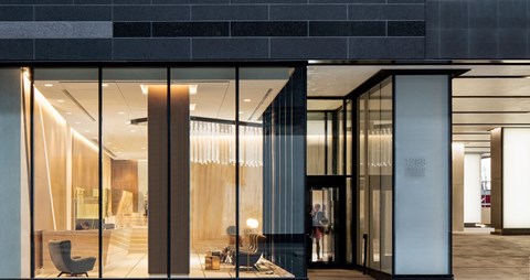 A modern building entrance with glass doors and a sign that reads "VAN".