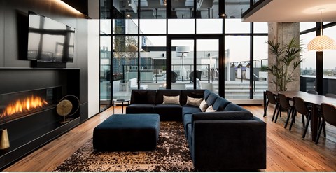 A modern living room with a fireplace and a large window.