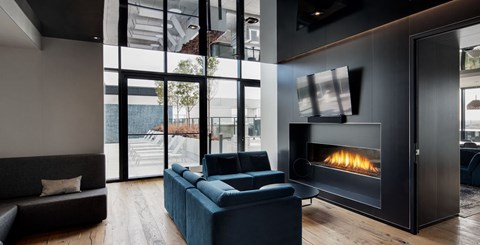 A modern living room with a fireplace and a view of the outdoors.