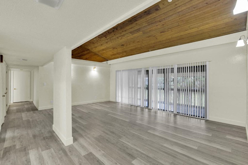 A room with wooden ceiling and grey flooring.