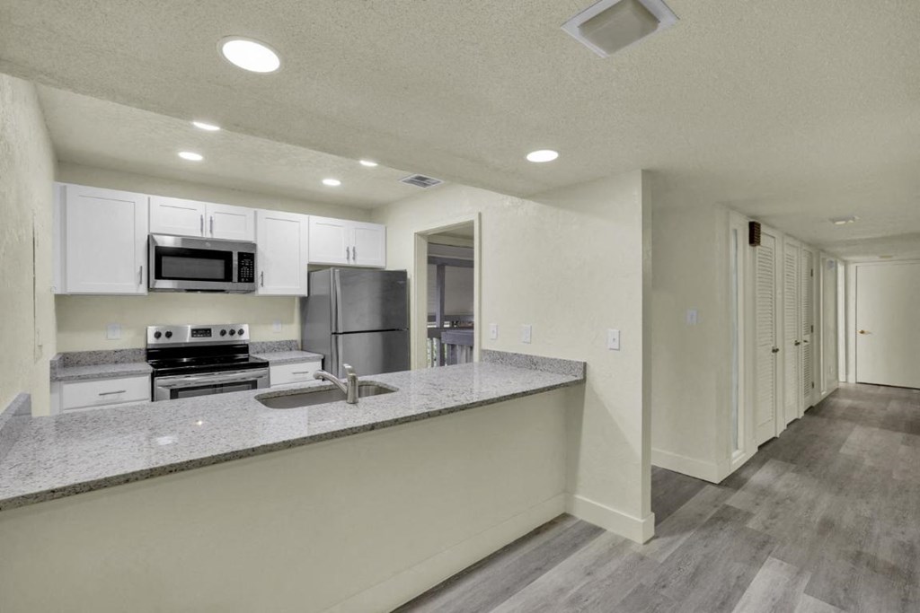 A kitchen with a countertop and a refrigerator.