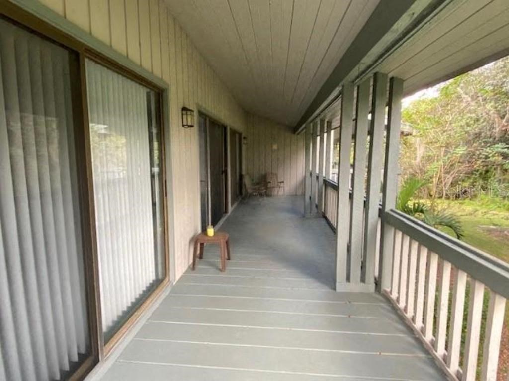 A wooden deck with a bench and railings.