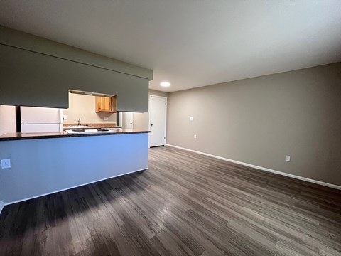 A kitchen with a counter and cabinets is visible in the image.