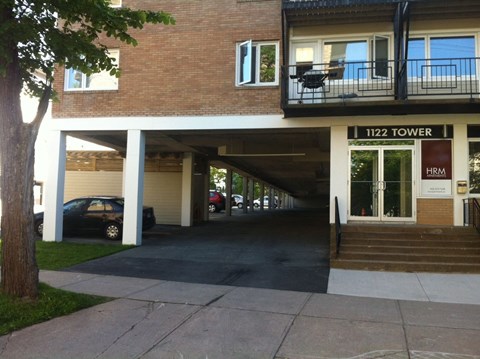 A car is parked in the garage of 1122 Tower.