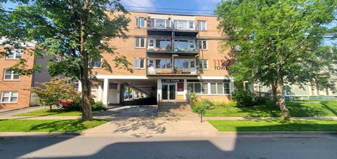 A large apartment building with a balcony on the second floor.
