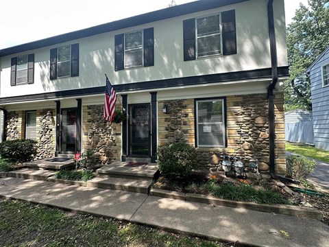 A house with a flag on the front porch.