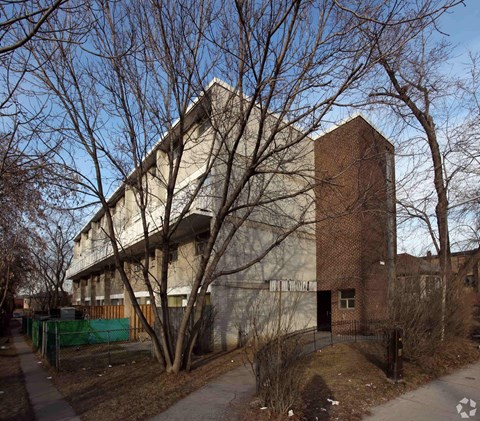 A large building with a tree in front of it.