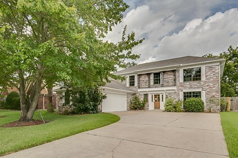 A house with a tree in front of it.