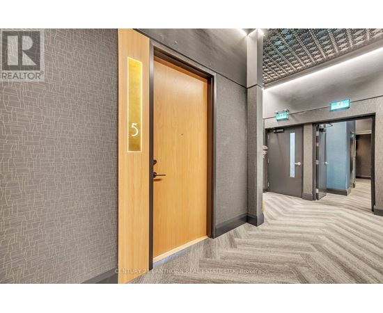 A hallway with a wooden door numbered 5.