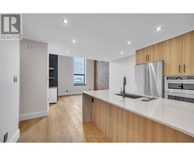 A modern kitchen with wooden cabinets and stainless steel appliances.