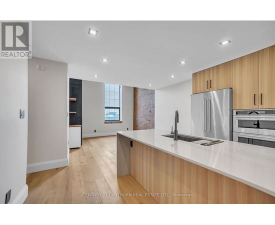 A modern kitchen with wooden cabinets and stainless steel appliances.