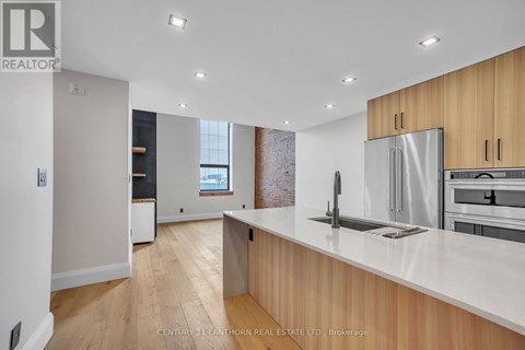 A modern kitchen with wooden cabinets and stainless steel appliances.
