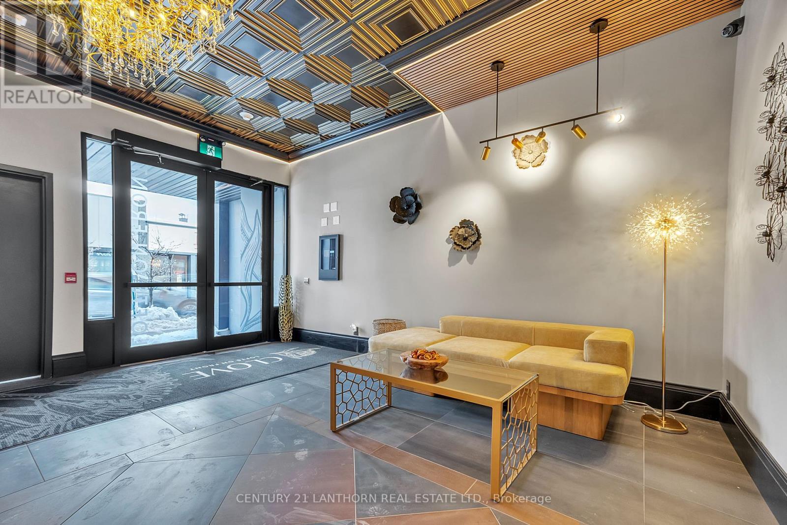 A modern living room with a yellow couch and a wooden coffee table.