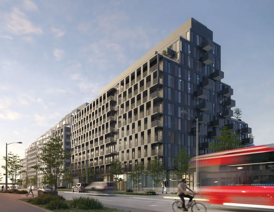 A modern building with a cyclist in front of it.