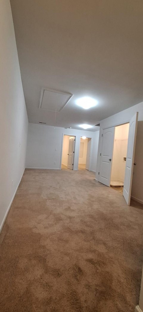 A room with carpeted floor and white walls.