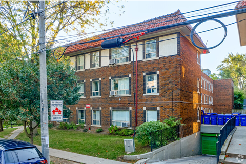 A red brick building with a sign that says "Protect Watch".