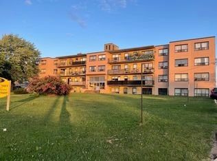 A grassy area in front of apartment buildings.