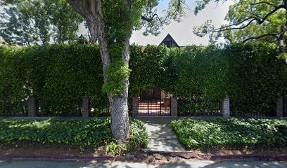 A house is surrounded by a wall of green ivy.