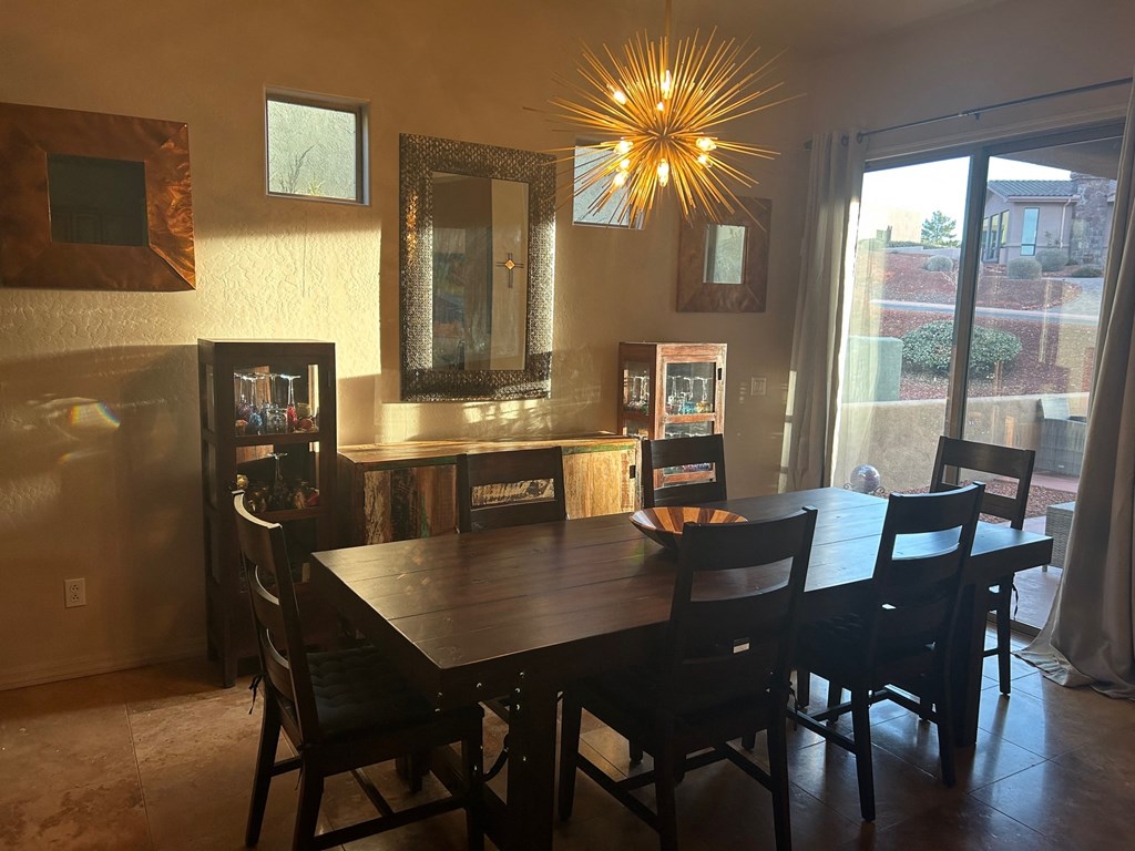 A dining room with a wooden table and chairs.
