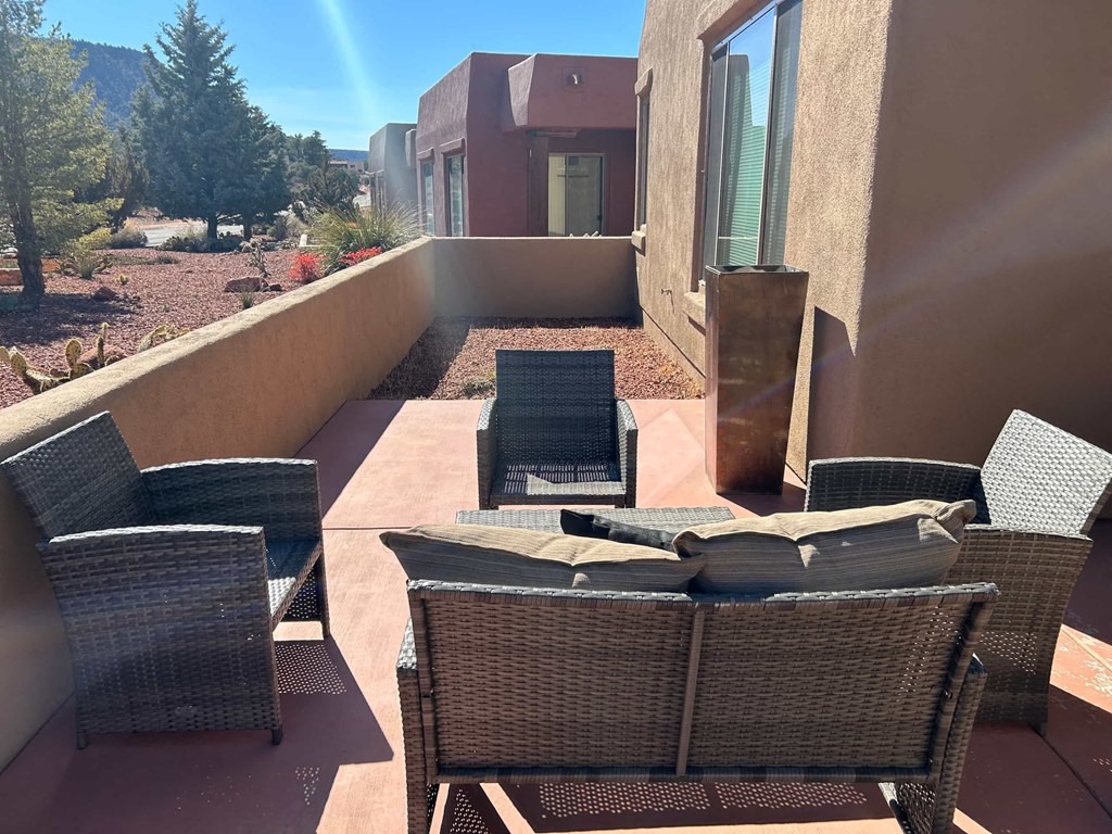 A patio with a table and chairs.