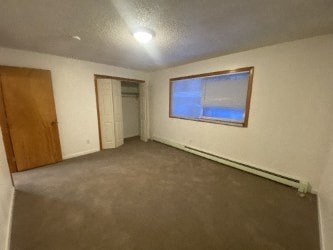 A room with a brown door and a window.