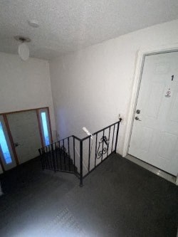 A room with a black railing and a white door.
