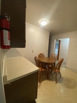 A dining room with a table and chairs.