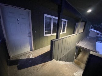 A stairway leading to a door with the number 5 on it.