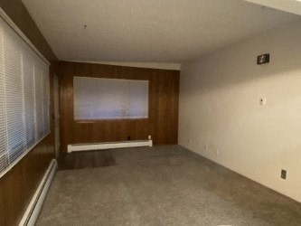 A room with a window and a bench.