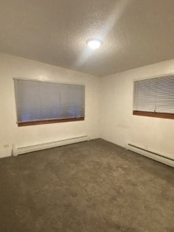 A room with a window covered by blinds and a ceiling light.