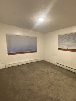 A room with a window covered by blinds and a ceiling light.